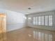 Sunlit living room showcases shuttered windows, retro flooring, and access to other rooms at 4915 Chariton Ave, Tampa, FL 33603