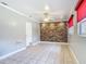 Living room featuring tile floors, ceiling fan, and a brick accent wall at 4915 Chariton Ave, Tampa, FL 33603