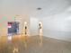 Open-concept living area with views into the den, kitchen, and retro flooring at 4915 Chariton Ave, Tampa, FL 33603