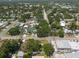 Expansive aerial view of a residential neighborhood with lush green trees, street access, and various home styles at 5106 15Th S Ave, Gulfport, FL 33707