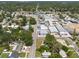 An aerial view of a community with many local shops, buildings, and homes surrounded by lush trees at 5106 15Th S Ave, Gulfport, FL 33707