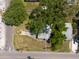 An aerial view of a house surrounded by trees and lush landscaping on a sunny day at 5106 15Th S Ave, Gulfport, FL 33707