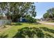 Spacious backyard with green grass and mature trees providing shade, creating a tranquil outdoor space at 5106 15Th S Ave, Gulfport, FL 33707