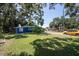 A home with a spacious backyard featuring green grass, driveway, and street access at 5106 15Th S Ave, Gulfport, FL 33707