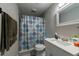 Bathroom features a shower with a patterned curtain, vanity with a white countertop, and gray walls at 5106 15Th S Ave, Gulfport, FL 33707