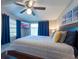 Cozy bedroom featuring a king-size bed, ceiling fan, and sliding glass door to the exterior at 5106 15Th S Ave, Gulfport, FL 33707