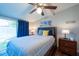 Comfortable bedroom featuring a large bed, ceiling fan, and a sliding glass door to the exterior at 5106 15Th S Ave, Gulfport, FL 33707