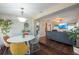Open dining area with hardwood floors and modern decor leading into the living room at 5106 15Th S Ave, Gulfport, FL 33707