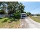 Charming blue cottage with a large front yard and mature trees, perfect for outdoor living at 5106 15Th S Ave, Gulfport, FL 33707