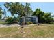 Quaint blue cottage featuring mature landscaping and an open front yard on a sunny day at 5106 15Th S Ave, Gulfport, FL 33707