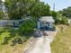 Charming home with a spacious driveway and a well-maintained lawn surrounded by mature trees at 5106 15Th S Ave, Gulfport, FL 33707