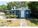 Charming single story home featuring a blue exterior with well-maintained landscaping and mature trees at 5106 15Th S Ave, Gulfport, FL 33707