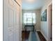 Hallway with wooden floors, natural light from the window, and coastal artwork on the walls at 5106 15Th S Ave, Gulfport, FL 33707