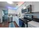 Updated kitchen featuring sleek white cabinets, stainless steel appliances, and modern lighting at 5106 15Th S Ave, Gulfport, FL 33707