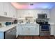 Modern kitchen design with stainless steel appliances and white cabinetry and countertops at 5106 15Th S Ave, Gulfport, FL 33707