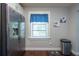This kitchen features stainless appliances, a window with blue curtains, and neutral walls at 5106 15Th S Ave, Gulfport, FL 33707