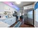 Updated kitchen with white cabinets, stainless steel appliances, and seamless flow into living area at 5106 15Th S Ave, Gulfport, FL 33707