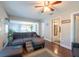 Inviting living room featuring hardwood floors, comfortable seating, and an open layout to the dining area at 5106 15Th S Ave, Gulfport, FL 33707