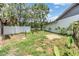Spacious backyard with grass, partial fence, and a view overlooking a serene pond at 5115 Stonehaven Ct, Tampa, FL 33624