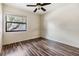 Bedroom featuring wood-look flooring and bright window view at 5115 Stonehaven Ct, Tampa, FL 33624