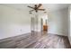Bedroom featuring wood-look flooring, ceiling fan, and ensuite bathroom at 5115 Stonehaven Ct, Tampa, FL 33624