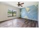 Bedroom with decorative wall, ceiling fan, and bright window view at 5115 Stonehaven Ct, Tampa, FL 33624