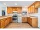 Updated kitchen with wood cabinets, stainless steel appliances, and granite countertops at 5115 Stonehaven Ct, Tampa, FL 33624