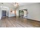 Bright living room featuring wood-look floors and access to sunroom and kitchen at 5115 Stonehaven Ct, Tampa, FL 33624