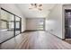 Bright living room featuring wood-look floors, ceiling fan and access to sunroom at 5115 Stonehaven Ct, Tampa, FL 33624
