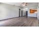 Spacious living area featuring wood-look floors, multiple doors and access to kitchen at 5115 Stonehaven Ct, Tampa, FL 33624