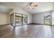 Open living space with wood-look floors, ceiling fan and access to sunroom at 5115 Stonehaven Ct, Tampa, FL 33624