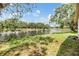 Scenic view of the pond surrounded by lush greenery and trees, visible from the property at 5115 Stonehaven Ct, Tampa, FL 33624
