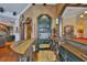 Stunning bar area featuring custom wood work, unique storage, bar seating, and adjacent billiards room at 5417 Tybee Island Dr, Apollo Beach, FL 33572