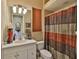 A cozy bathroom featuring a vanity, a toilet, and a shower with a decorative curtain at 5417 Tybee Island Dr, Apollo Beach, FL 33572