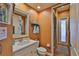Bathroom with a walk-in shower, white vanity, decorative mirror, and warm paint color scheme at 5417 Tybee Island Dr, Apollo Beach, FL 33572