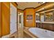 This bathroom is equipped with modern fixtures, wood trim, a large vanity, and lots of natural light at 5417 Tybee Island Dr, Apollo Beach, FL 33572