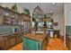 Open kitchen with custom cabinets, stainless appliances, tile backsplash, and center island at 5417 Tybee Island Dr, Apollo Beach, FL 33572
