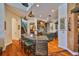 Gourmet kitchen with copper countertops, eat-in island, stainless appliances, and terra cotta tile flooring at 5417 Tybee Island Dr, Apollo Beach, FL 33572