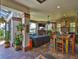 The lanai features a living and dining space, stone fireplace, outdoor kitchen, and views of the water at 5417 Tybee Island Dr, Apollo Beach, FL 33572