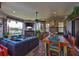 Lanai with a waterfront view, stone fireplace, dining table, outdoor kitchen, and comfortable furniture at 5417 Tybee Island Dr, Apollo Beach, FL 33572
