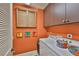 Laundry room with modern machines, storage cabinets, bright wall color and unique decorative elements at 5417 Tybee Island Dr, Apollo Beach, FL 33572
