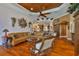 Well-decorated living room with hardwood floors, custom ceiling, and views of the kitchen through an archway at 5417 Tybee Island Dr, Apollo Beach, FL 33572