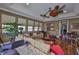 Living room featuring hardwood floors, large windows, ceiling fans, seating, and open layout at 5417 Tybee Island Dr, Apollo Beach, FL 33572