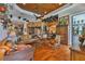 Cozy living room with hardwood floors, custom ceiling, and access to multiple rooms through archways at 5417 Tybee Island Dr, Apollo Beach, FL 33572