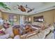 Large living room with lots of natural light, ceiling fans, plenty of seating, and hardwood floors at 5417 Tybee Island Dr, Apollo Beach, FL 33572