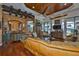Beautiful living room with wood floors, a decorative ceiling, a full bar, and views of the pool at 5417 Tybee Island Dr, Apollo Beach, FL 33572