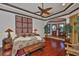 This beautiful bedroom features stylish decor, hardwood floors and a cozy seating area near a large window at 5417 Tybee Island Dr, Apollo Beach, FL 33572