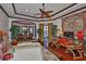 An expansive primary suite featuring a tray ceiling, dark wood trim, and direct access to the backyard at 5417 Tybee Island Dr, Apollo Beach, FL 33572