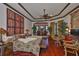 Spacious main bedroom with decorative ceiling fan, access to seating area, and hardwood floors at 5417 Tybee Island Dr, Apollo Beach, FL 33572