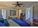 Relaxing bedroom featuring a comfortable bed, stylish furnishings, hardwood floors, and serene ambiance at 5417 Tybee Island Dr, Apollo Beach, FL 33572